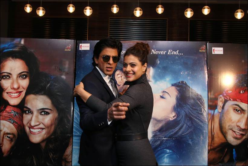 Shah Rukh Khan, left and Kajol pose for photographers