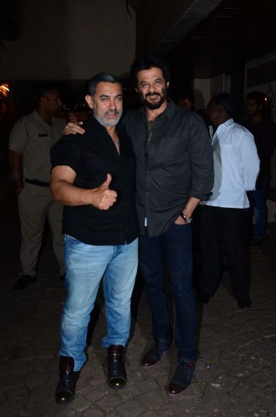Aamir Khan dressed in black shirt and blue jeans with birthday boy Anil Kapoor