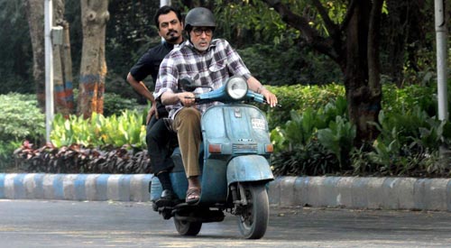 Amitabh Bachchan riding a scooter