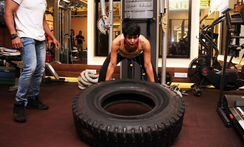 Mandira Bedi lifting a tyre