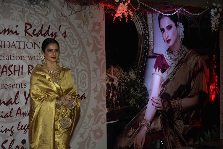 Rekha poses besides with her poster