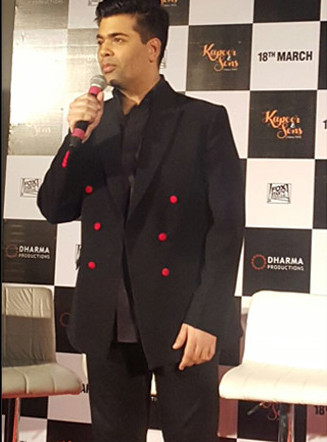 Karan Johar looking dapper in black blazer embedded with red buttons at Kapoor & Sons Trailer Launch