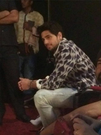Sidharth Malhotra in a printed white blazer on stage at Kapoor & Sons Trailer Launch