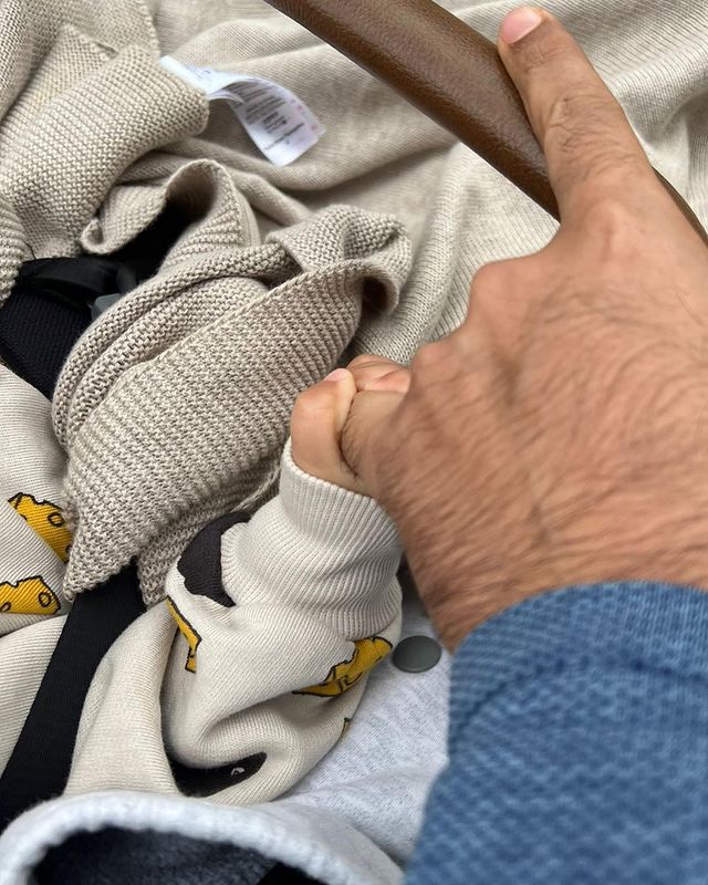 Anand Ahuja holding little Vayu's hand